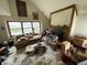 Living area in need of repair with natural light, fireplace, and spacious layout potential at 2517 Baur Dr, Indianapolis, IN 46220