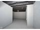 Finished section of the basement with freshly painted concrete walls and ceiling with an open layout at 2714 N Capitol Ave, Indianapolis, IN 46208