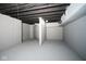 Unfinished basement space with neutral walls, a gray floor, and open ceilings with painted pipes at 2714 N Capitol Ave, Indianapolis, IN 46208