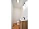 Updated half bathroom with a modern vanity, fixtures, and lighting with hardwood flooring at 2714 N Capitol Ave, Indianapolis, IN 46208