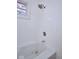Bright bathroom featuring a tub with shower and white tile surround at 2714 N Capitol Ave, Indianapolis, IN 46208