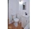 Bathroom featuring a pedestal sink, modern faucet, and tiled walls at 2714 N Capitol Ave, Indianapolis, IN 46208