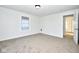 Bright bedroom featuring neutral carpet, a window with natural light, and fresh, white walls at 2714 N Capitol Ave, Indianapolis, IN 46208