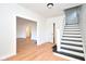 Bright foyer featuring hardwood floors, painted walls, and a staircase with updated black trim at 2714 N Capitol Ave, Indianapolis, IN 46208