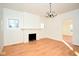 Open-concept living room showcases hardwood floors, a decorative light fixture, and fireplace at 2714 N Capitol Ave, Indianapolis, IN 46208