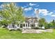 Spacious backyard with lush green grass, mature trees, and a brick patio area perfect for entertaining at 2979 Kings Ct, Carmel, IN 46032