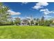 Expansive backyard featuring lush green lawn, mature trees, and an elegant home with large windows at 2979 Kings Ct, Carmel, IN 46032