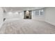 Large finished basement with plush carpet, stone fireplace and ample natural light from the windows at 2979 Kings Ct, Carmel, IN 46032