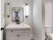 Bathroom with a vanity, rectangular mirror, and modern lighting fixtures at 2979 Kings Ct, Carmel, IN 46032