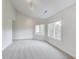 This bedroom is filled with natural light from many windows, offering a bright and inviting space with plush carpets at 2979 Kings Ct, Carmel, IN 46032