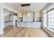 Bright dining room with hardwood floors, built-in cabinets, and modern light fixtures at 2979 Kings Ct, Carmel, IN 46032