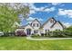 Beautiful two-story white brick home with a well-manicured lawn and a blue front door at 2979 Kings Ct, Carmel, IN 46032