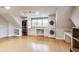 Bright laundry room boasts wooden floors, modern appliances, sink and countertop, and natural light from large windows at 2979 Kings Ct, Carmel, IN 46032
