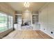 Cozy living room featuring a stone fireplace, built-in bookshelves, and bright windows at 2979 Kings Ct, Carmel, IN 46032