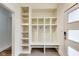 Bright mud room with custom built-ins, bench seating, and modern door at 2979 Kings Ct, Carmel, IN 46032