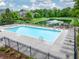 Community pool featuring lounge chairs, a pond with a fountain, and a playground for residents to enjoy at 2979 Kings Ct, Carmel, IN 46032