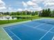 Tennis court set amongst green spaces, near a pond at 2979 Kings Ct, Carmel, IN 46032