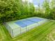 Aerial view of a fenced tennis court surrounded by a green space at 2979 Kings Ct, Carmel, IN 46032