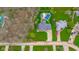 Aerial view showcases the property with its pool and well-defined landscaping at 310 Edgewood E Pl, Anderson, IN 46011