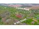 Aerial view showing the property's approximate location near Layton Road and W 8th Street in a wooded neighborhood at 310 Edgewood E Pl, Anderson, IN 46011