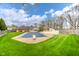 Expansive backyard with pool, pergola, and well-manicured lawn at 310 Edgewood E Pl, Anderson, IN 46011