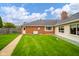 Manicured backyard with generator and plenty of green space at 310 Edgewood E Pl, Anderson, IN 46011