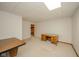 Spacious unfinished basement with neutral carpet, desk and storage access at 310 Edgewood E Pl, Anderson, IN 46011