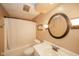 Bathroom featuring a shower/tub, sink with a vanity and round mirror at 310 Edgewood E Pl, Anderson, IN 46011