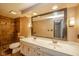 Spacious bathroom featuring double sinks, large mirror and tiled shower at 310 Edgewood E Pl, Anderson, IN 46011