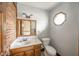 Bathroom with a unique octagon window and brick accent wall at 310 Edgewood E Pl, Anderson, IN 46011