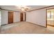 Spacious carpeted bedroom featuring multiple wooden closets and a doorway to a bathroom at 310 Edgewood E Pl, Anderson, IN 46011
