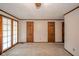 A carpeted bedroom featuring a closet, and glass paned doors leading to the outside at 310 Edgewood E Pl, Anderson, IN 46011