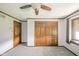 The carpeted bedroom features a large window and a closet with wooden doors at 310 Edgewood E Pl, Anderson, IN 46011