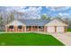 Charming brick home with well-maintained lawn, two-car garage and welcoming front porch at 310 Edgewood E Pl, Anderson, IN 46011