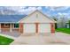 Spacious two-car garage with brick accents and concrete driveway at 310 Edgewood E Pl, Anderson, IN 46011