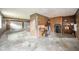 Attached garage boasts a concrete floor, wood paneling, and space for storage and vehicles at 310 Edgewood E Pl, Anderson, IN 46011