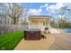 Outdoor hot tub with an adjacent pergola and surrounding greenery at 310 Edgewood E Pl, Anderson, IN 46011