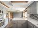 Spacious kitchen with gray cabinets, white countertops and hardwood floors at 310 Edgewood E Pl, Anderson, IN 46011
