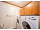 Bright laundry room featuring a modern washer and dryer, with ample storage cabinets above at 310 Edgewood E Pl, Anderson, IN 46011