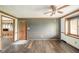 Living room with hardwood floors, wood trim, and natural light from large window at 310 Edgewood E Pl, Anderson, IN 46011