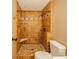 A tiled shower featuring a built-in seat and decorative tilework at 310 Edgewood E Pl, Anderson, IN 46011
