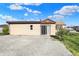 A well-maintained single-story home featuring a large gravel lot and grassy area at 3104 Poplar St, Anderson, IN 46012