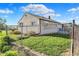 Fenced backyard with grass and shrubbery at 3104 Poplar St, Anderson, IN 46012
