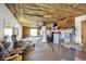 Finished basement with suspended ceiling, rocking chairs, and recreation area at 3104 Poplar St, Anderson, IN 46012
