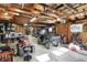 Spacious garage featuring exposed wood beam ceiling, ATV, UTV and tool storage at 3104 Poplar St, Anderson, IN 46012