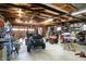 Spacious garage featuring exposed wood beam ceiling, roll up door and tool storage at 3104 Poplar St, Anderson, IN 46012