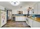 Bright kitchen with white cabinets, stainless steel appliances, and wood-look flooring at 3104 Poplar St, Anderson, IN 46012
