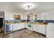 Bright eat-in kitchen features white cabinetry and modern appliances at 3104 Poplar St, Anderson, IN 46012