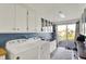 Convenient laundry room with ample storage, modern machines, and exterior access at 3104 Poplar St, Anderson, IN 46012
