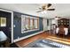 Open-concept living area with hardwood floors, large windows, and stylish decor at 3104 Poplar St, Anderson, IN 46012
